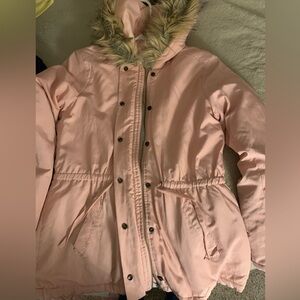 Winter coat with faux fur on the hood and wool lining inside.